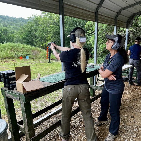 Shooting under the watchful eye of National Shooting Champion Lisa Munson at She Never Quit